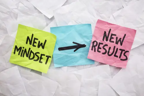 new mindset and results new mindset and new results  concept - colorful sticky notes on a background of crumpled white notes